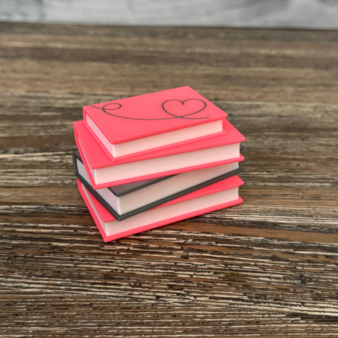 Romance novel light up book stack sitting on a wooden shelf.